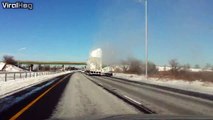 Snow explodes as an overloaded tractor trailer drives underneath a bridge!