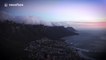 Timelapse shows clouds blow from top of Table Mountain as sun sets
