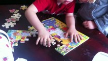 Jip and Janneke making big Winnie the Pooh puzzle