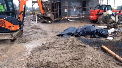 Mini Excavator working with very wet mud.