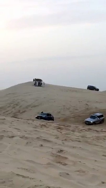 Sand drifting, cars upside down
