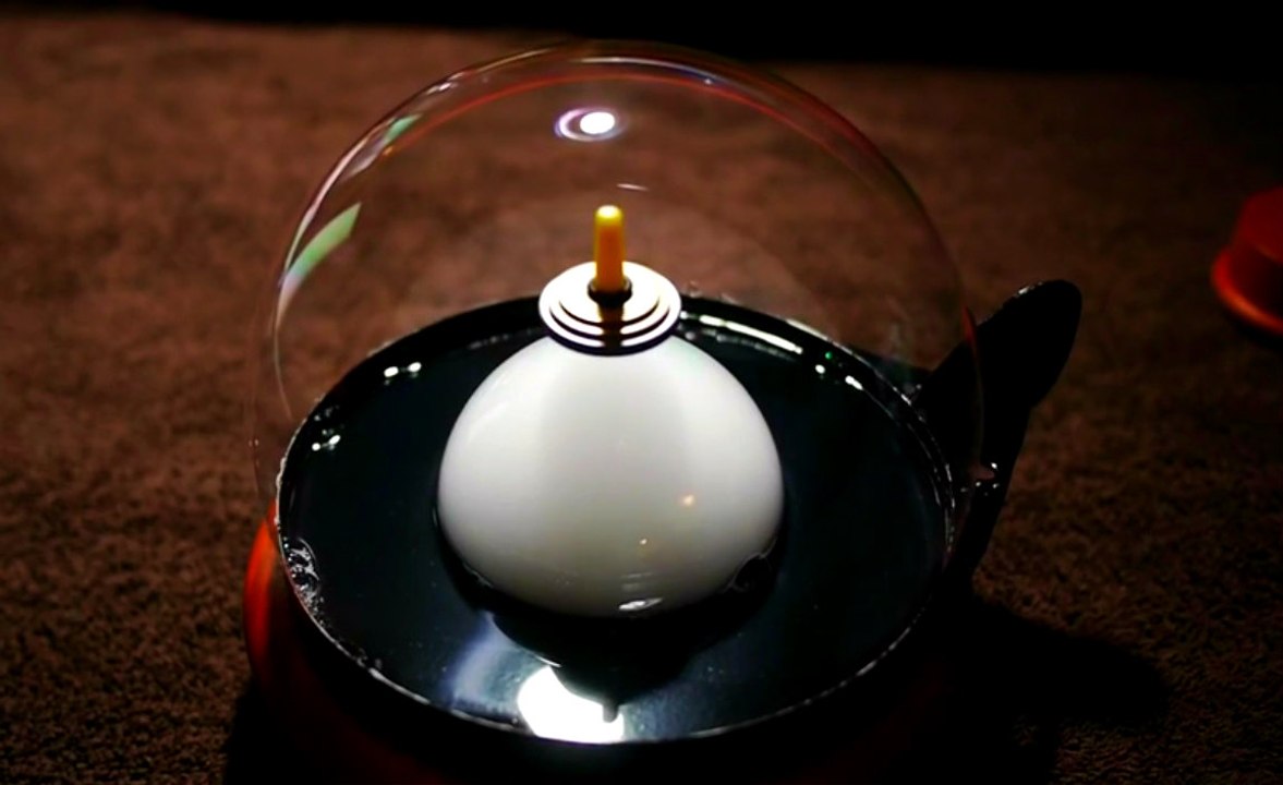 Levitating Top Inside A Smoke Filled Bubble