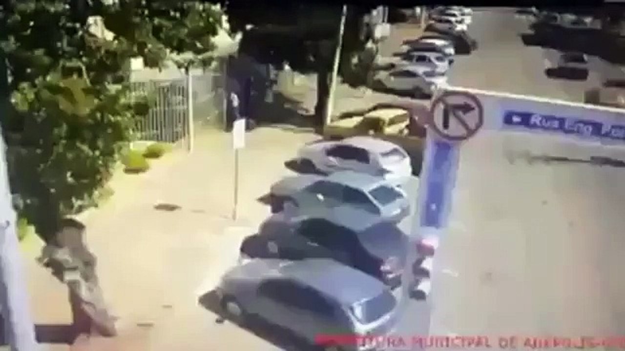 Incredible moment a driver in Brazil runs over a man throwing stones at his car