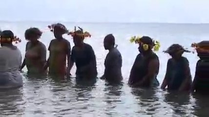 Woman drumming on Water in Vanuatu Islands for traditional Ceremony