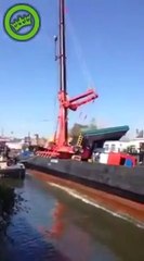 Woman cries while Crane falling from construction barge in Netherlands