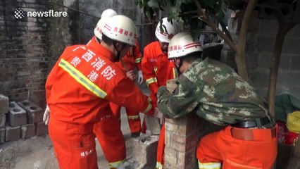 Firefighters save two children stuck between two walls