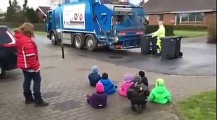 Danish children in daycare watching the garbagetruck