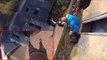 Daredevil hangs from 150ft high tower with just one hand