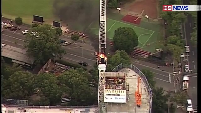 VIDEO: Moment burning crane collapses at construction site on Melbourne's St Kilda Road