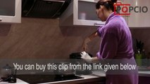 A woman adds to the saucepan sour cream dollop (video stock footage)