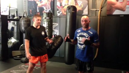 Joe Rogan kicks really hard while Duane Bang Ludwig holds pads