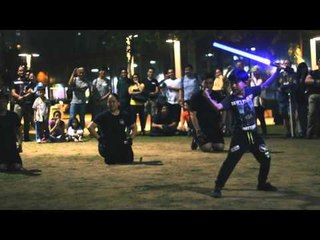 Crowd Cheer for Father and Son's Impressive Lightsaber Duel