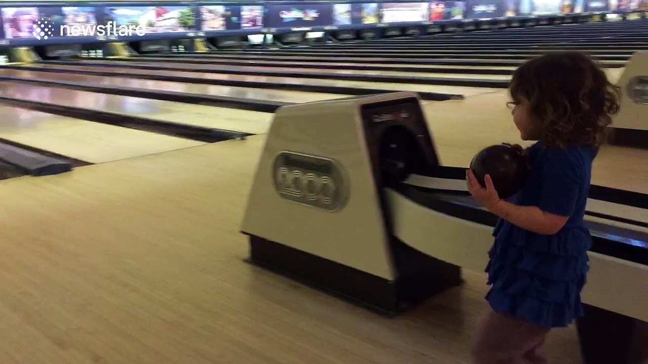 Little girl taken bowling by her dad... doesn't quite get it
