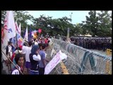 Protesters walk around police barricade on Commonwealth Ave