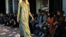 Marjane walking (very slowly) in a gold paillette dress with subtle flower detail at Rochas