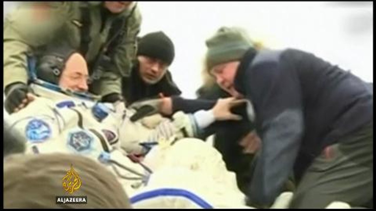 Astronauts return to earth after 340 days in space