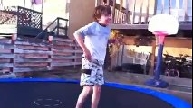 Kid jumps off ledge onto trampoline twice.
