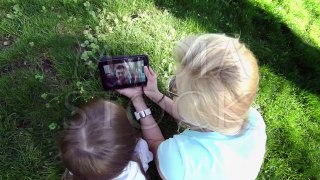 Mother and daughter using digital tablet to communicate with his father