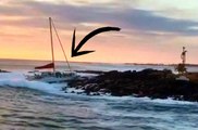 Big Wave Pushes a Catamaran Into The Rocks