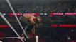 Seth Rollins hits a flying elbow drop onto the announce table- S