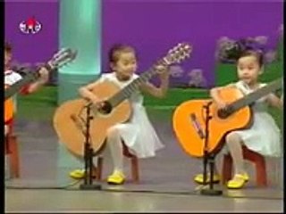North Korea children playing the guitar. Creepy as hell.