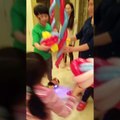 Kids play a balloon clown twister's basketball on self-balancing scooter at a birthday party in Richmond BC