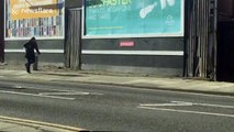 Woman dances her way down street in Liverpool