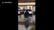 Man rides shopping trolley in bizarre attempt to avoid Dubai floodwater