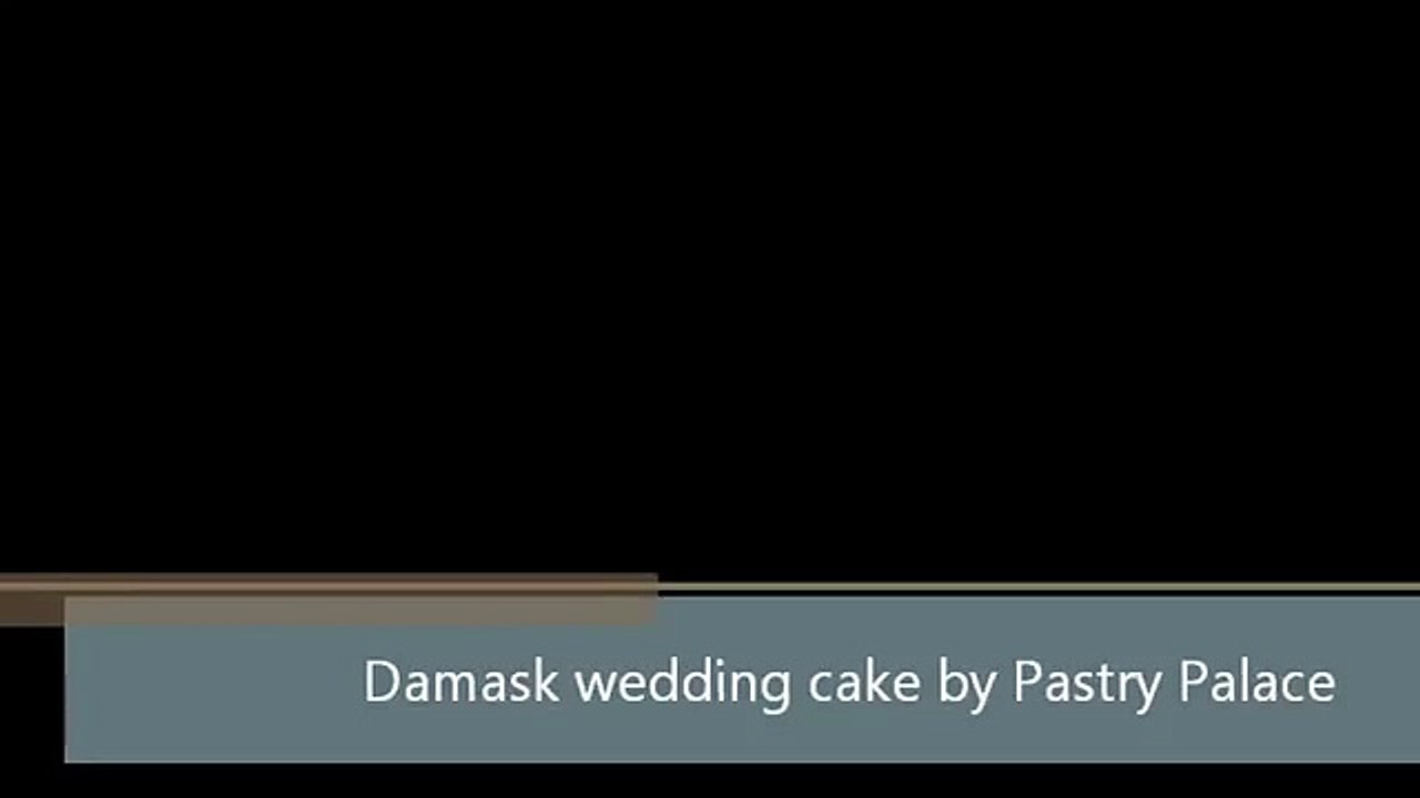 Damask pattern wedding cake with red roses