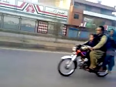 Boy wheeling on Bike with his Girl Friend