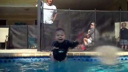 Talented baby jumps in and swims across pool