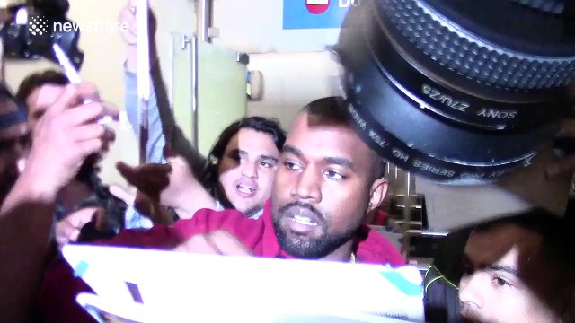 Kanye West mobbed on arrival at LAX airport