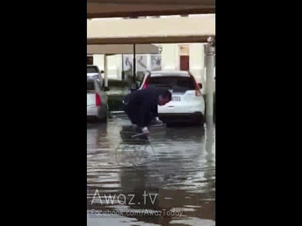 Desperate Man Trapped in Shopping Cart During Extreme Rain in Abu Dhabi