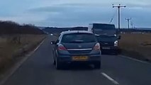 Impatient driver has near-miss with oncoming traffic while overtaking cars on a busy road
