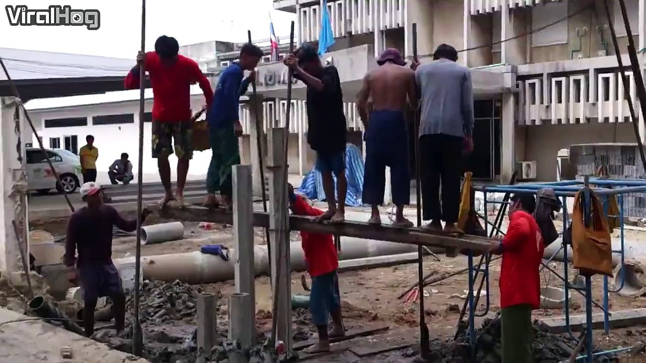 These construction workers show they don't need heavy machinery to set a foundation