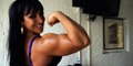 world fitness Big muscle woman flexing her powerful 16 inch biceps