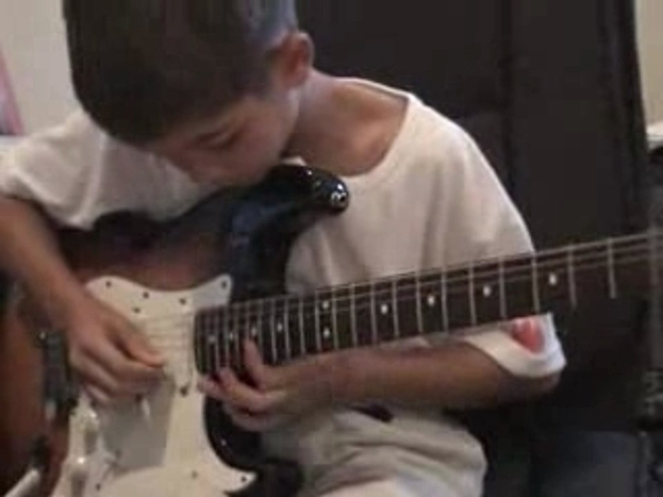 Kid playing the guitar  Zeppelin