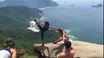 Would you take a picture dangling over this cliff? These people are