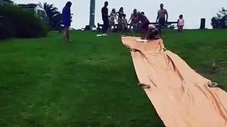 Old Man Falls Surfing Down Slip n' Slide