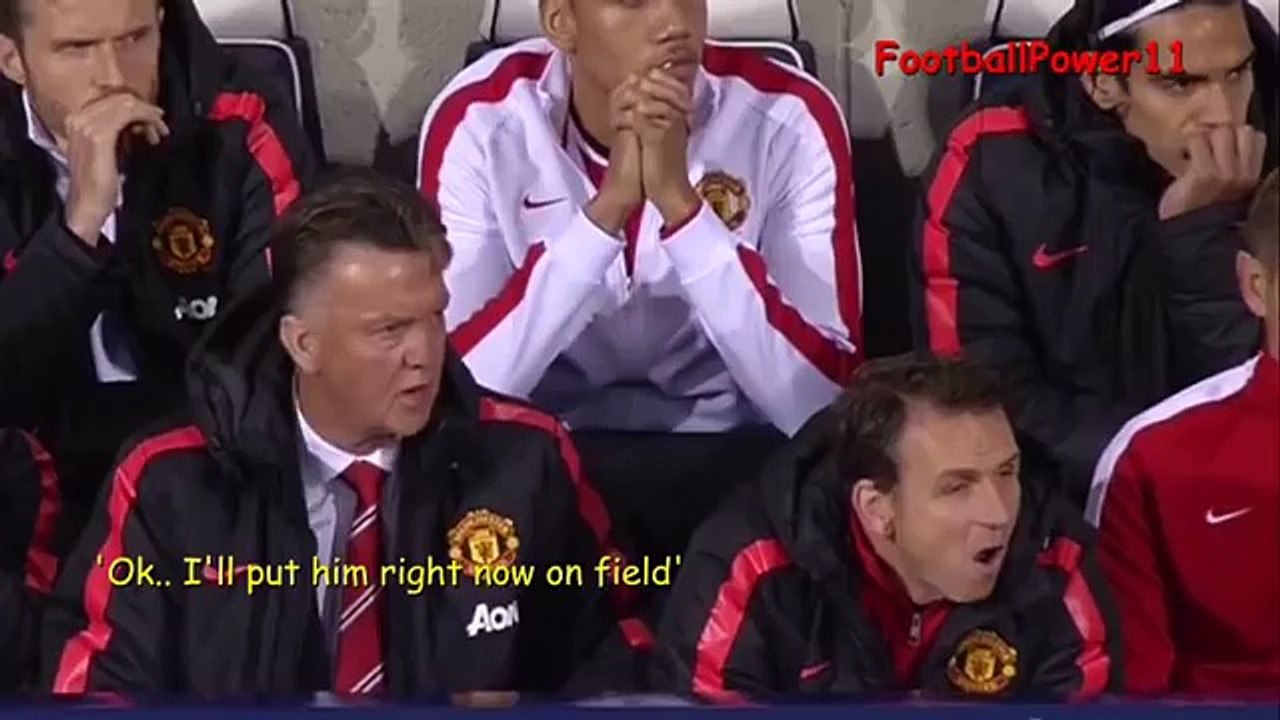 Louis Van Gaal talking with Fellaini on bench during the match