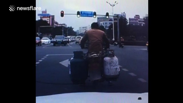 Motorbike carrying gas cylinders bursts into flames