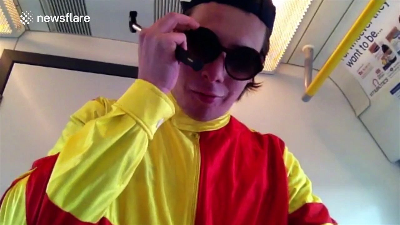 Man, dressed as jockey, rides bike through train carriages in 'urban horse riding' stunt