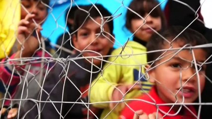Baby on a dinghy held up to Turkish coastguard