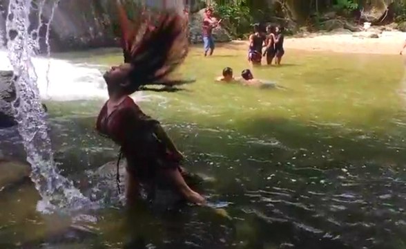 Woman Gracefully Wets Her Hair Like A Diva