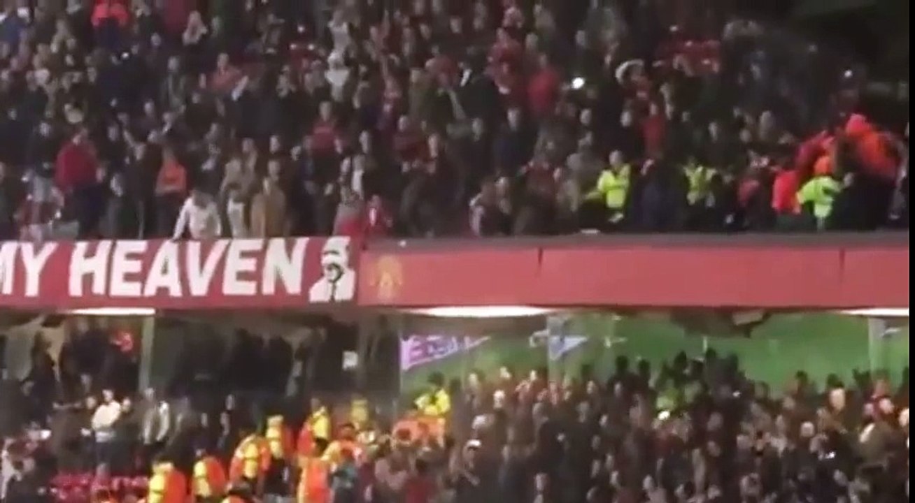 Fans of Manchester United and Liverpool clash at Old Trafford . amateur camera