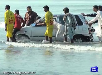 Two cars parked at Karachi beach sweep into sea