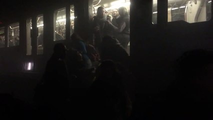 Commuters climb out of Brussels Metro train after explosion