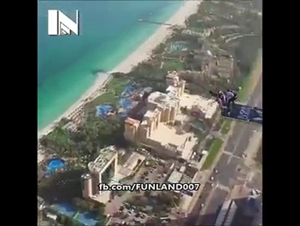 man jumps to big bulding in air