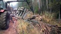 Full trailer of wood turned over, Belarus Mtz 892.2 forestry tractor helps to get up