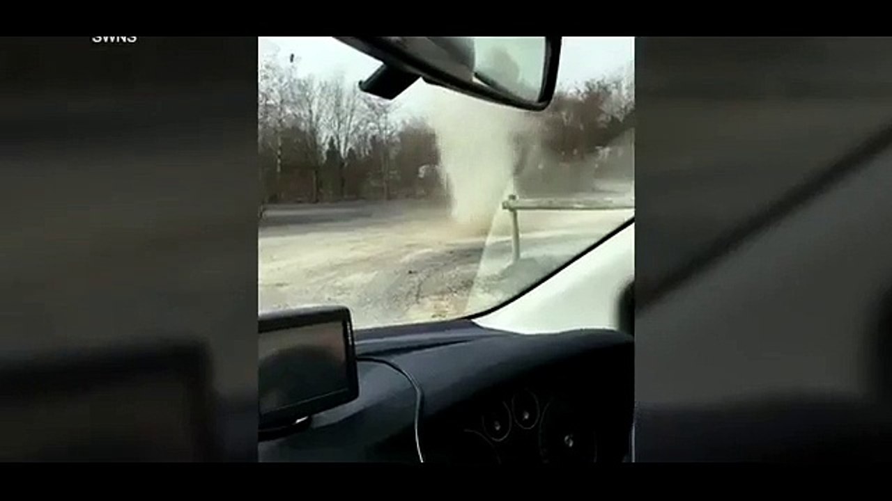 Incredible moment a 'dust devil' surges through carpark